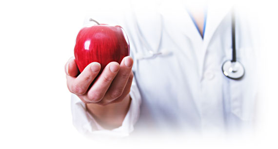 Doctor holding up red apple