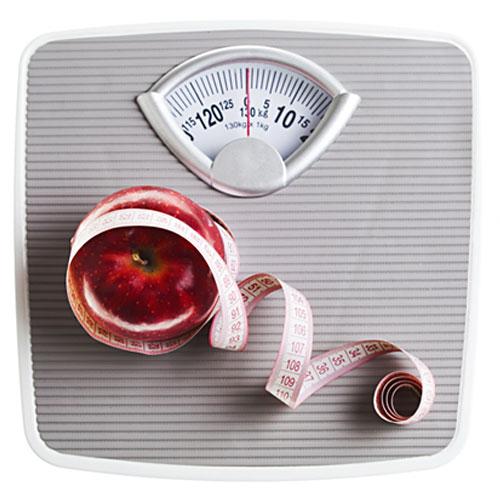 Weight scales with apple and tape measure
